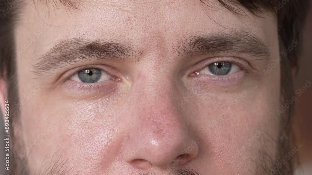 The expressive look of a bearded man with blue eyes. Close-up. The man looks directly into the camera. Slow motion. High quality 4k footage The expressive look of a bearded man with blue eyes. Close-up. The man looks directly into the camera. Slow motion. High quality 4k footage