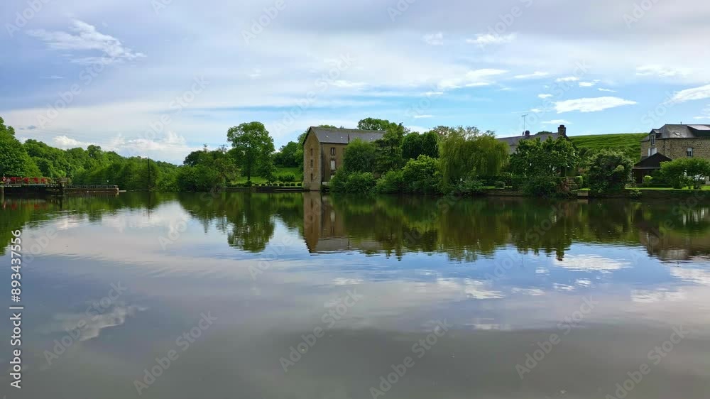Drone flying over water surface of Mayenne River. Saint-Baudelle lock or weir in background, France. Aerial drone forward, low attitude Drone flying over water surface of Mayenne River. Saint-Baudelle lock or weir in background, France. Aerial drone forward, low attitude