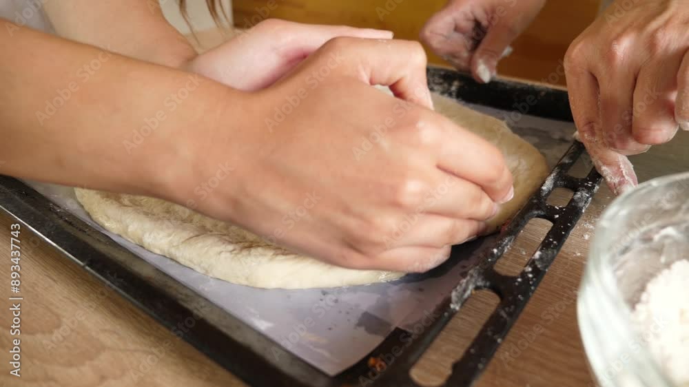 The dough is formed in a form for baking pizza. The dough is formed in a form for baking pizza.