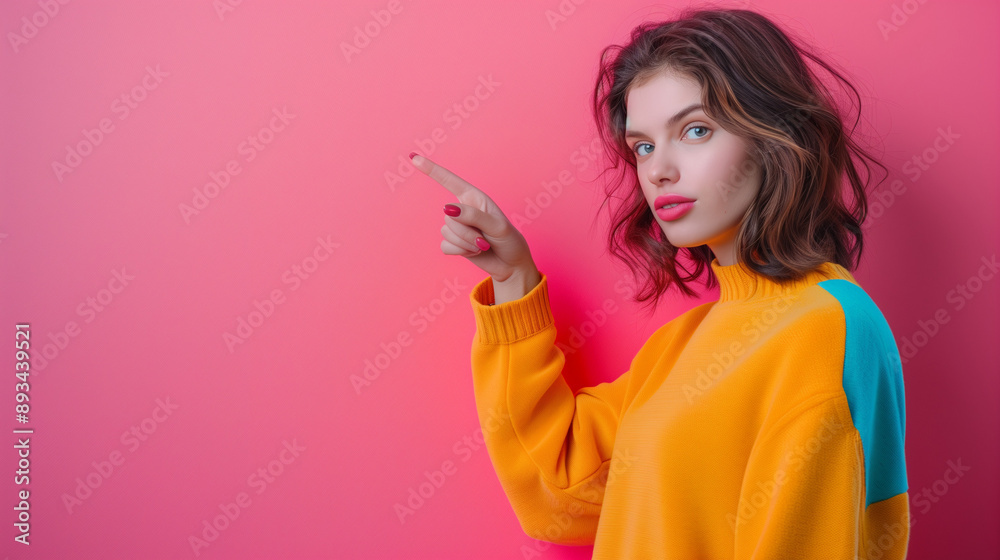 Portrait of a beautiful woman pointing her fingers isolated on a pastel background. Portrait of a beautiful woman pointing her fingers isolated on a pastel background.