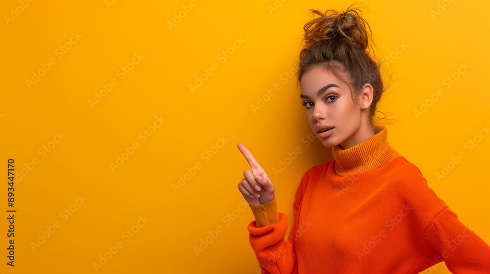 Portrait of a young woman pointing her fingers isolated on a pastel background. Portrait of a young woman pointing her fingers isolated on a pastel background.