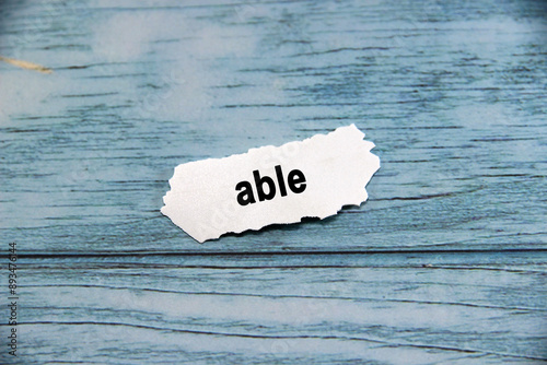 able Text or message short word english letter on white paper with blue pantern background.