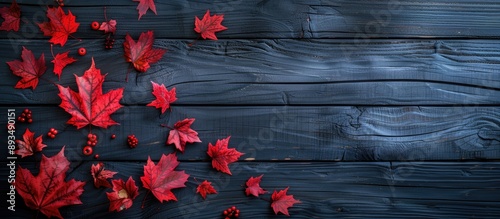 Autumn themed with red maple leaves on a dark wooden backdrop creating a striking image with copy space available