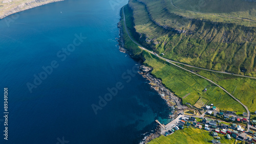 Funningur village, Faroe Islands. Sunny day in summer. Amazing nature in Faroe Islands. Eysturoy Island. Gonguturur or Hvithamar Trailhead. Faroese fjord and summits