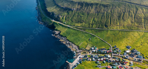 Funningur village, Faroe Islands. Sunny day in summer. Amazing nature in Faroe Islands. Eysturoy Island. Gonguturur or Hvithamar Trailhead. Faroese fjord and summits