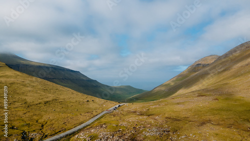 Funningur village, Faroe Islands. Sunny day in summer. Amazing nature in Faroe Islands. Eysturoy Island. Gonguturur or Hvithamar Trailhead. Faroese fjord and summits