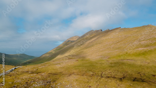 Funningur village, Faroe Islands. Sunny day in summer. Amazing nature in Faroe Islands. Eysturoy Island. Gonguturur or Hvithamar Trailhead. Faroese fjord and summits