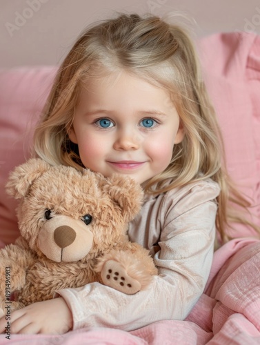 A young child cuddling her favorite stuffed animal, perfect for family and kid-related projects