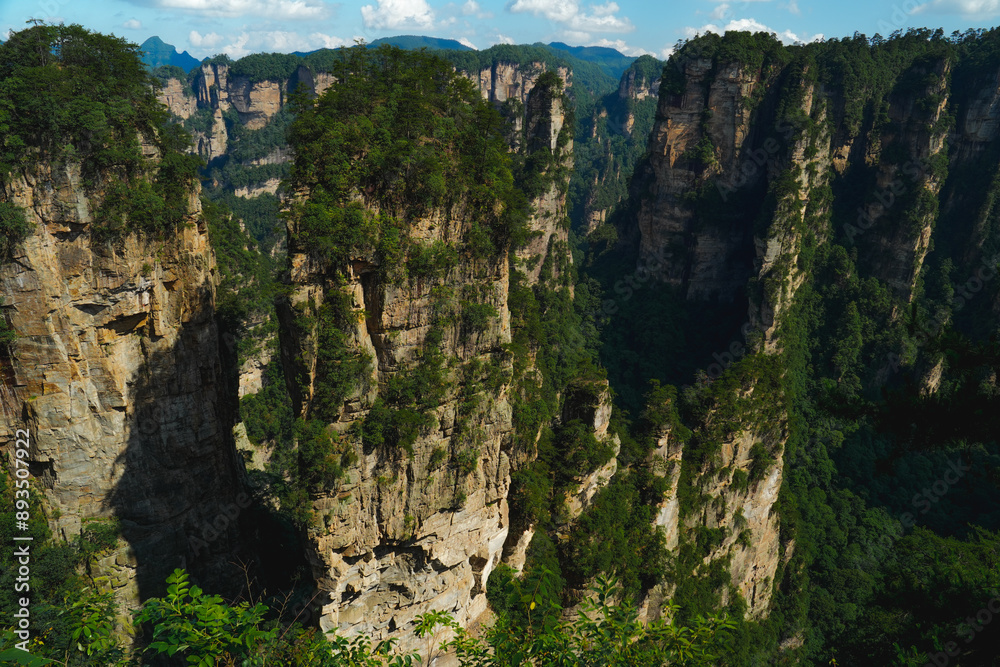 Fototapeta premium Zhangjiajie national forest park, China, Glass bridge of Zhangjiajie China Tianzishan with blue sky, concept of world heritage, avatar, heritage peak or cliff mountain, tourist attraction famous place
