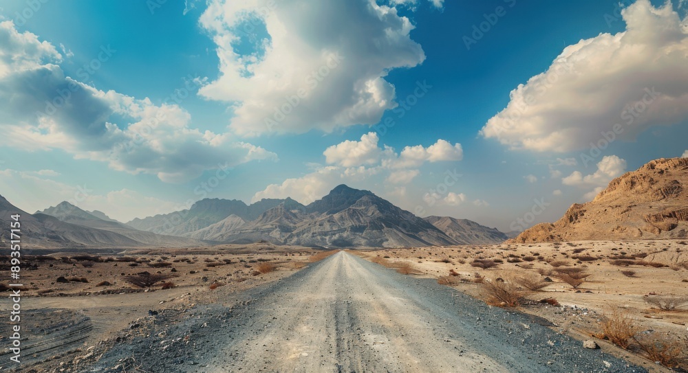 Naklejka premium Dirt Road in Dubai's Hajar Mountains: A Captivating View of Middle East Beauty