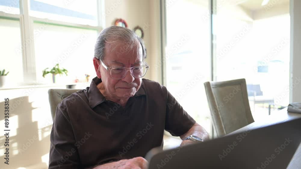 senior citizen in disbelief as he reads an internet article about inflation senior citizen in disbelief as he reads an internet article about inflation