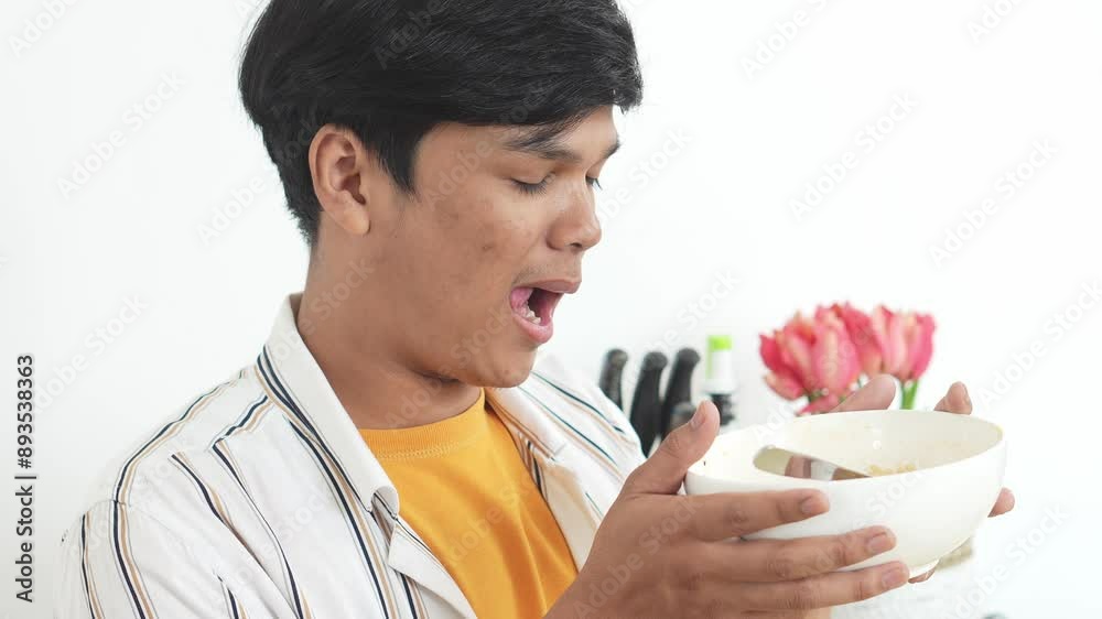 Close Up Of Asian Young Man, Smelling Freshly Cooked Instant Noodle In Bowl, Enjoying Food Aroma And Smiling Close Up Of Asian Young Man, Smelling Freshly Cooked Instant Noodle In Bowl, Enjoying Food Aroma And Smiling