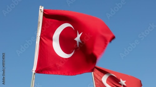 Turkish flags are waving in the wind on a clear day. Turkish flag waving in the wind.