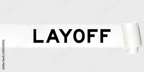 Ripped gray paper background that have word layoff under torn part