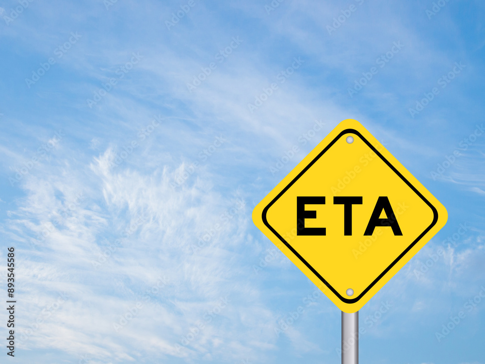 Yellow transportation sign with word ETA (abbreviation of estimated time of arrival) on blue color sky background Yellow transportation sign with word ETA (abbreviation of estimated time of arrival) on blue color sky background