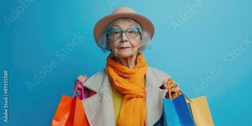 Senior woman carrying groceries and wearing a hat on a sunny day