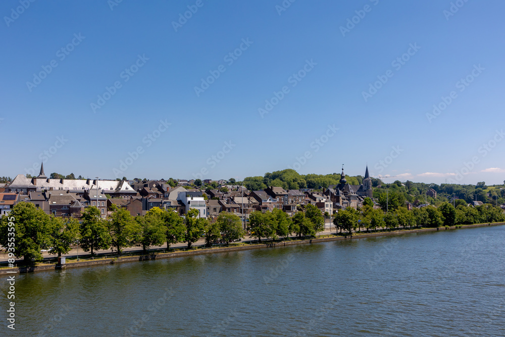 Summer cityscape with view of Vise city in Belgium under blue sky, Architecture traditional house and church along the Meuse river, Visé is a city and municipality of Wallonia in the province of Liège Summer cityscape with view of Vise city in Belgium under blue sky, Architecture traditional house and church along the Meuse river, Visé is a city and municipality of Wallonia in the province of Liège