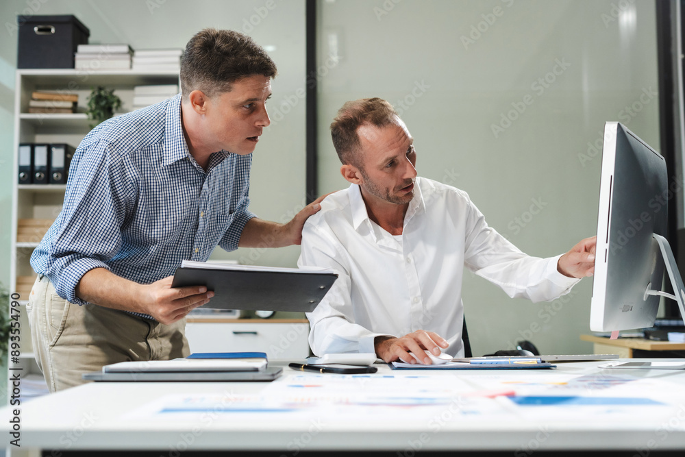 Caucasian business team working at office with laptop and documents on desk, financial adviser analyzing data. Caucasian business team working at office with laptop and documents on desk, financial adviser analyzing data.