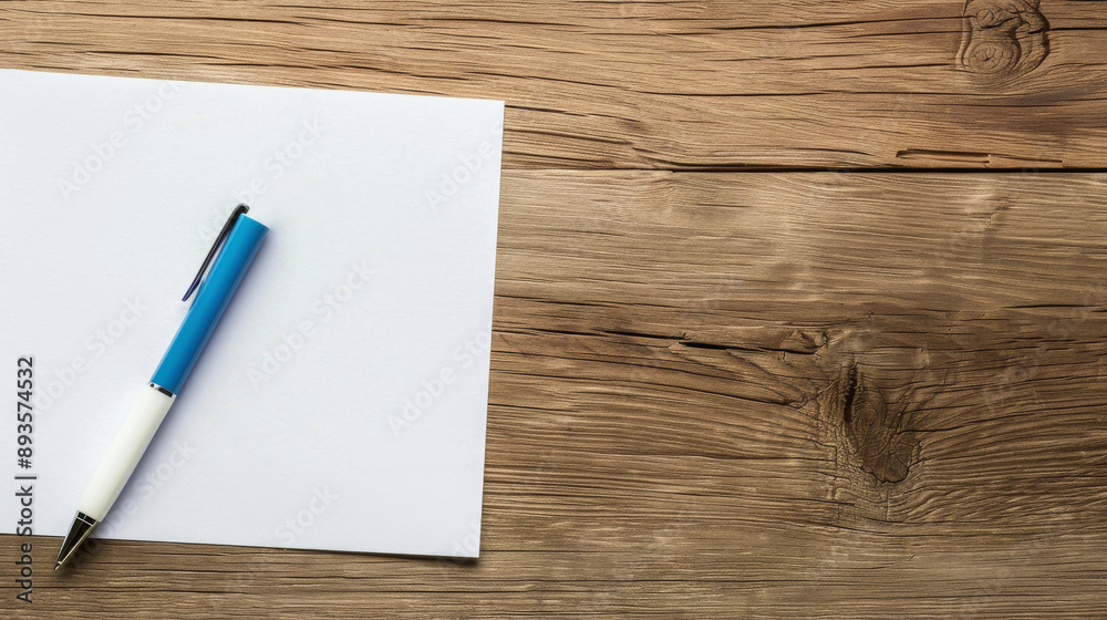 Pen and paper on a wooden table Pen and paper on a wooden table