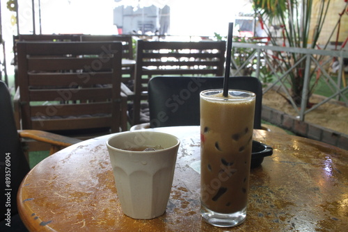 A Glass of Black Coffee and a cup of Tea at a Cafe in Vietnam