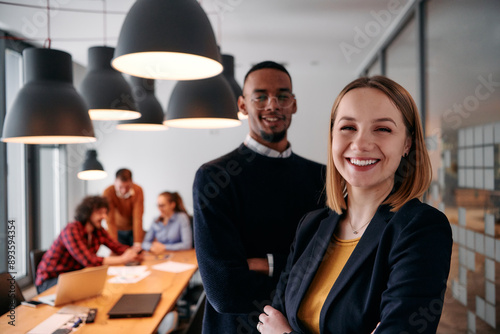 Dynamic Leadership Duo: Blonde Director and Young African American Entrepreneur in Office Setting. photo