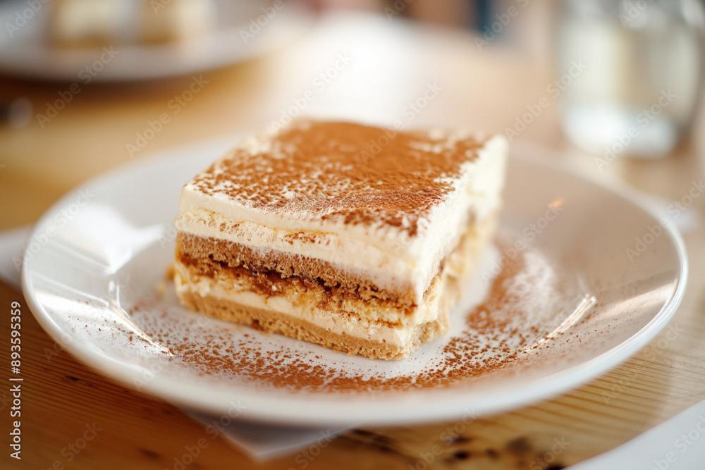 Tiramisu desert on a cafe table - popular italian dish Tiramisu desert on a cafe table - popular italian dish
