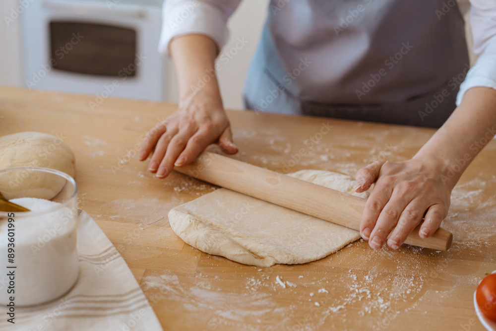 woman's hands kneading dough on the kitchen table
woman's hands kneading dough on the kitchen table