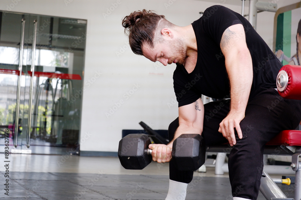 Young man exercising in the fitness center Exercise for health. Young man exercising in the fitness center Exercise for health.