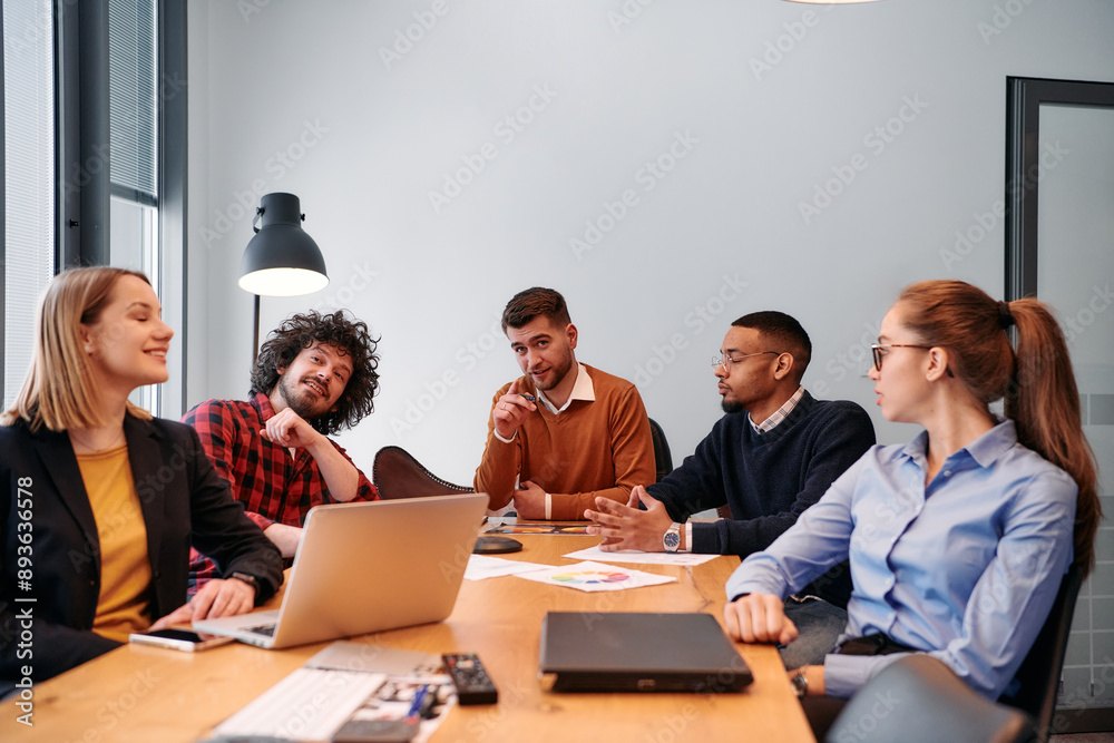 Dynamic Entrepreneurial Team Strategizing Projects in Modern Office Meeting. Dynamic Entrepreneurial Team Strategizing Projects in Modern Office Meeting.