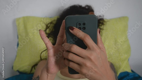 People are playing on their smartphones before going to bed.