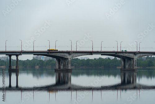 View of road bridge across river and embankment Dnipro city Ukraine. Panorama central automobile bridge.