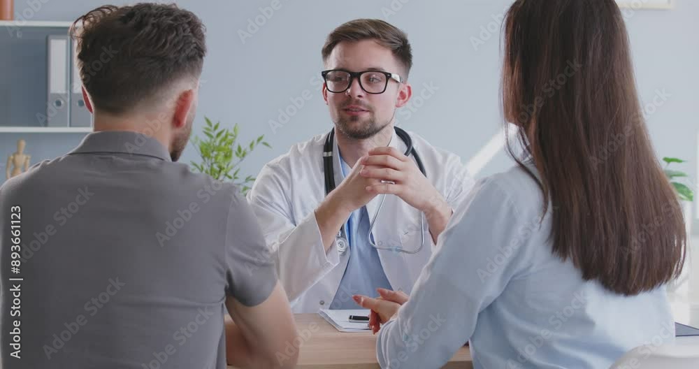 Positive pregnancy planning doctor consulting a couple during a ...