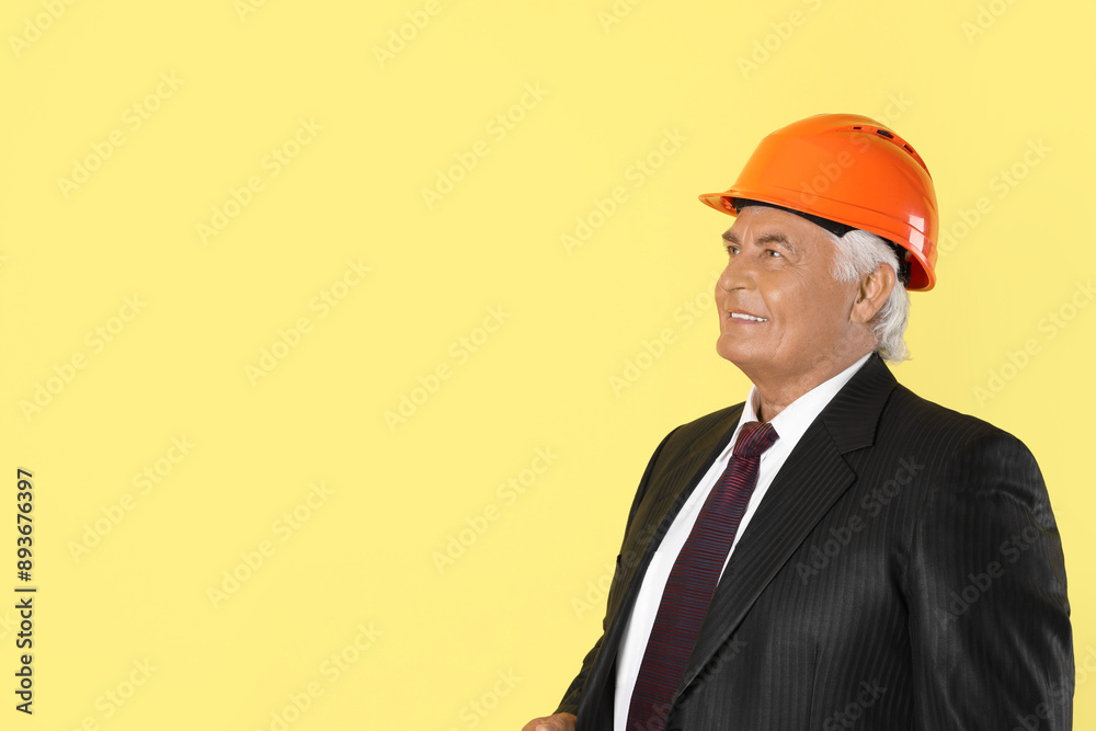 Engineer in hard hat on yellow background, space for text Engineer in hard hat on yellow background, space for text