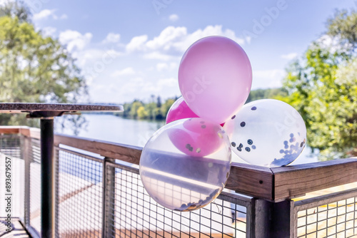 Decorative balloons on a reiling at a wedding photo