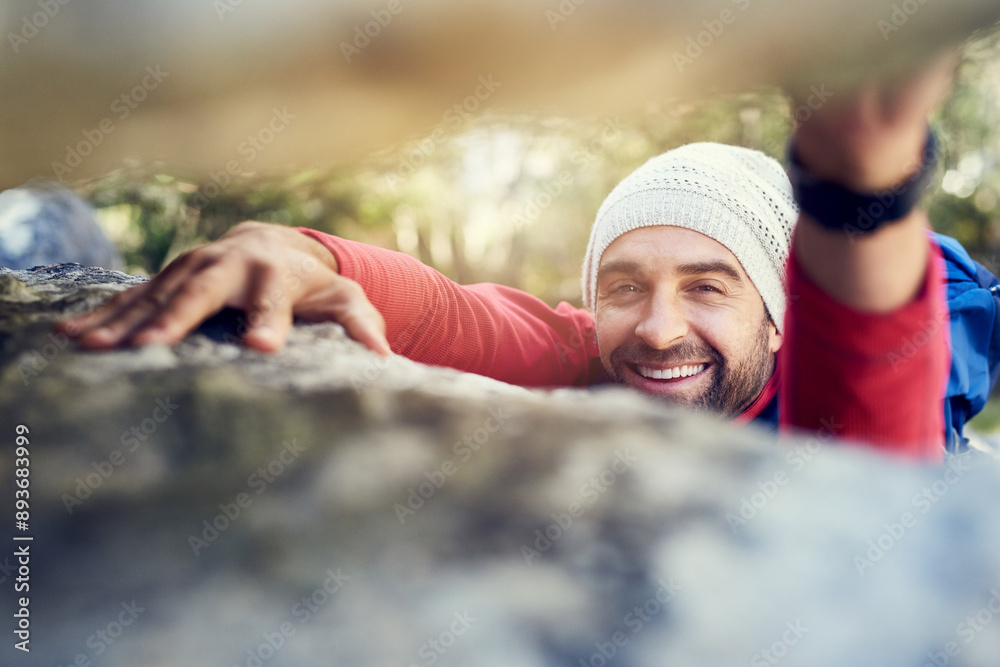 Man, portrait and climbing on rock in mountain for adventure, sports and explore with fitness and backpack. Trekking, person or scrambling on cliff in nature with smile for exercise challenge on hill Man, portrait and climbing on rock in mountain for adventure, sports and explore with fitness and backpack. Trekking, person or scrambling on cliff in nature with smile for exercise challenge on hill