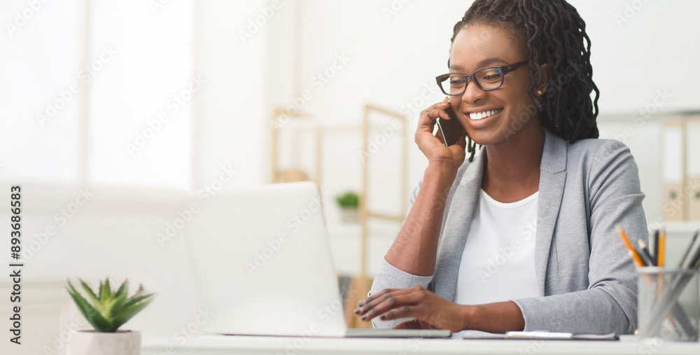 Lady Boss. Afro Businesswoman Talking On Cellphone While Working On Laptop In Modern Office, Wide Horizontal Banner, Panorama With Free Space