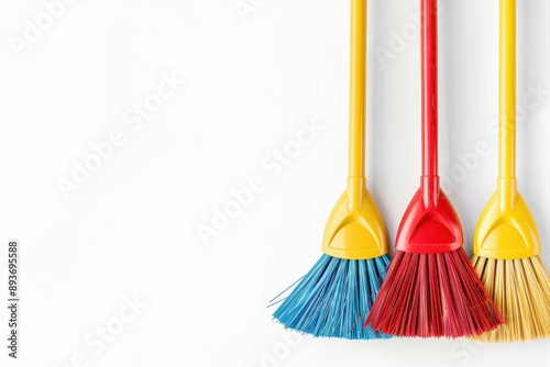 Plastic brooms and dustpans on white background top view for banner design