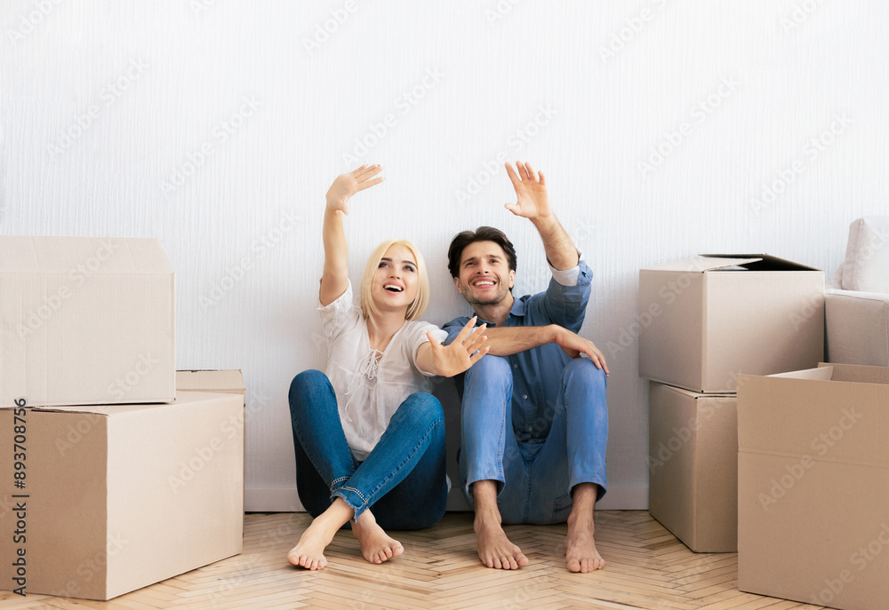 Moving Apartment. Husband And Wife Talking Sitting On Floor Planning Interior Design For New Home. Free Space Moving Apartment. Husband And Wife Talking Sitting On Floor Planning Interior Design For New Home. Free Space