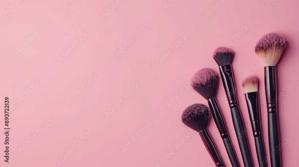 Makeup brushes on pink background with copy space Top view presentation of cosmetic tools Makeup brushes on pink background with copy space Top view presentation of cosmetic tools