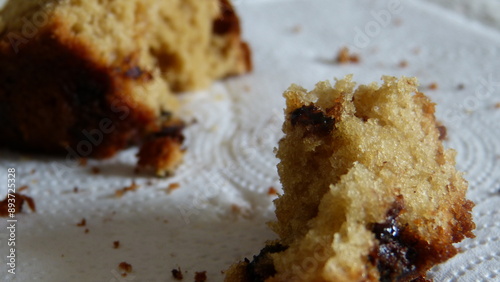 Close up of chocolate chip muffin and crumbs.