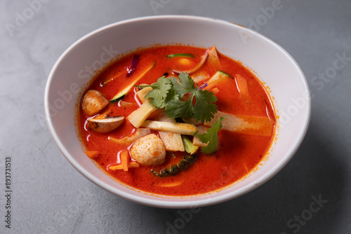 Tasty asian soup with shrimps and vegetables served on plate. 