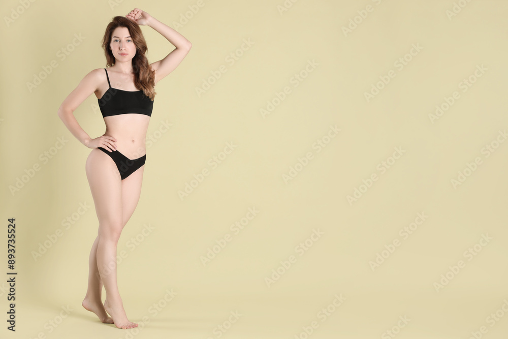 Fototapeta premium Woman with slim body posing on olive background, space for text