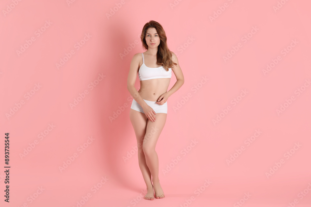 Woman with slim body posing on pink background Woman with slim body posing on pink background