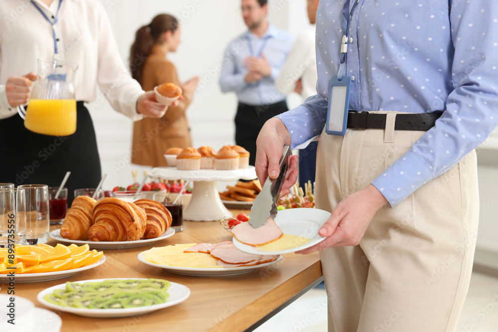 Coworkers having business lunch in restaurant, closeup Coworkers having business lunch in restaurant, closeup