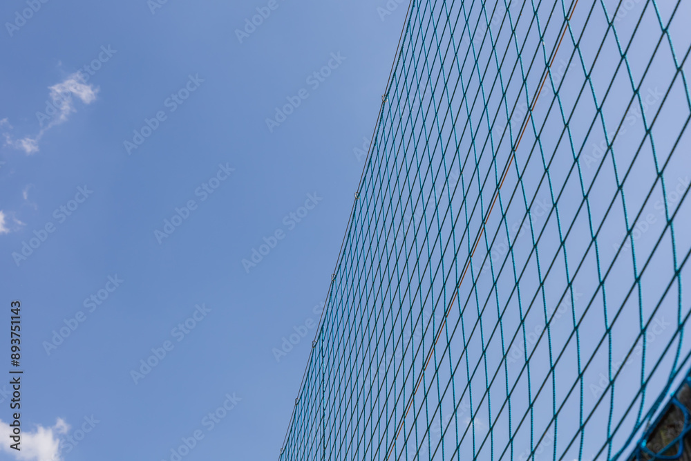 Protective netting on a volleyball court. Blue sky. Protective netting on a volleyball court. Blue sky.