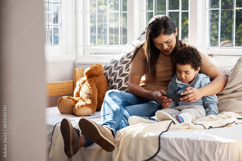 Home, phone and mother with kid on bed for online education, video games and website. Family, child development and mom bonding with boy with cellphone in home for internet learning and entertainment Home, phone and mother with kid on bed for online education, video games and website. Family, child development and mom bonding with boy with cellphone in home for internet learning and entertainment