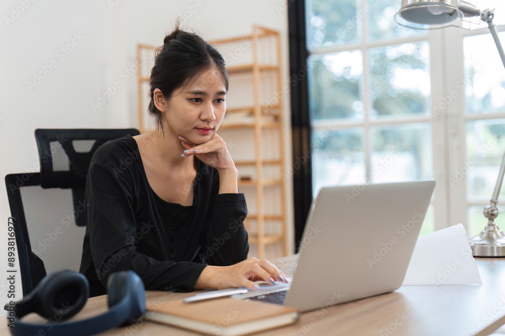 Young Accountant Working on Financial Documents at Home with Laptop in Modern Home Office Setting Young Accountant Working on Financial Documents at Home with Laptop in Modern Home Office Setting