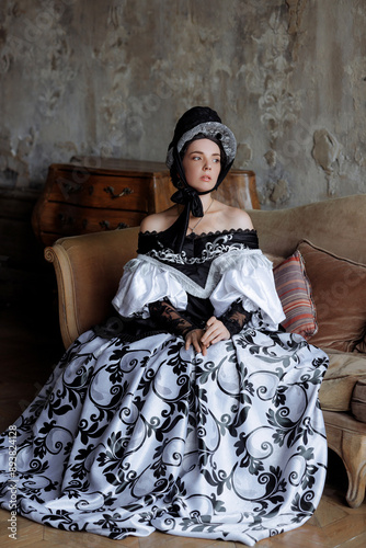 A caucasian woman, mid-30s, exudes aristocratic grace in a richly embroidered Baroque gown. Ideal for fashion editorials, historical romance book covers, or interior design concepts.