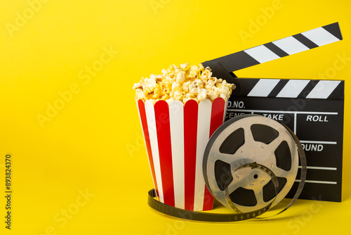 Tasty popcorn in buckets and cold cola drinks with cinema tickets, movie clapper and 3D eyeglasses on a bright colored background. Cinema concept. Watching a movie.Place for text. Copy space