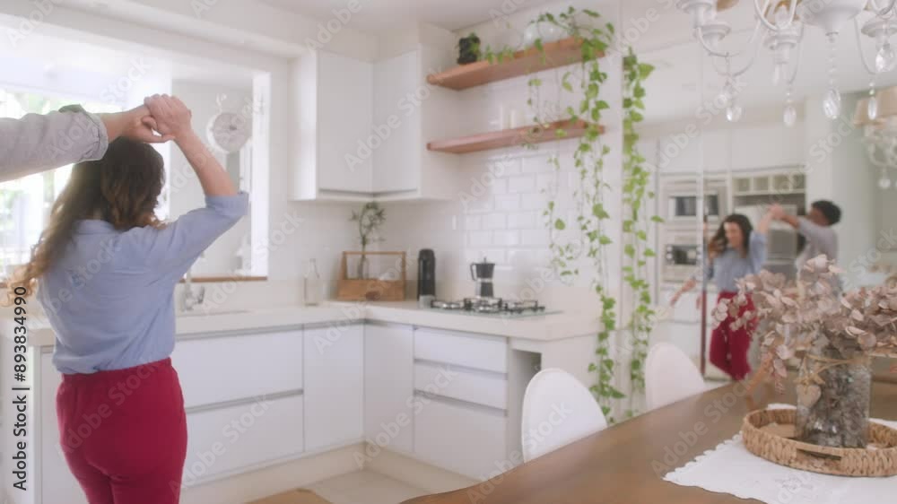 Cheerful gay couple dancing in the kitchen and having fun at home Cheerful gay couple dancing in the kitchen and having fun at home